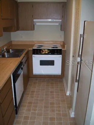 a stove top oven sitting inside of a kitchen