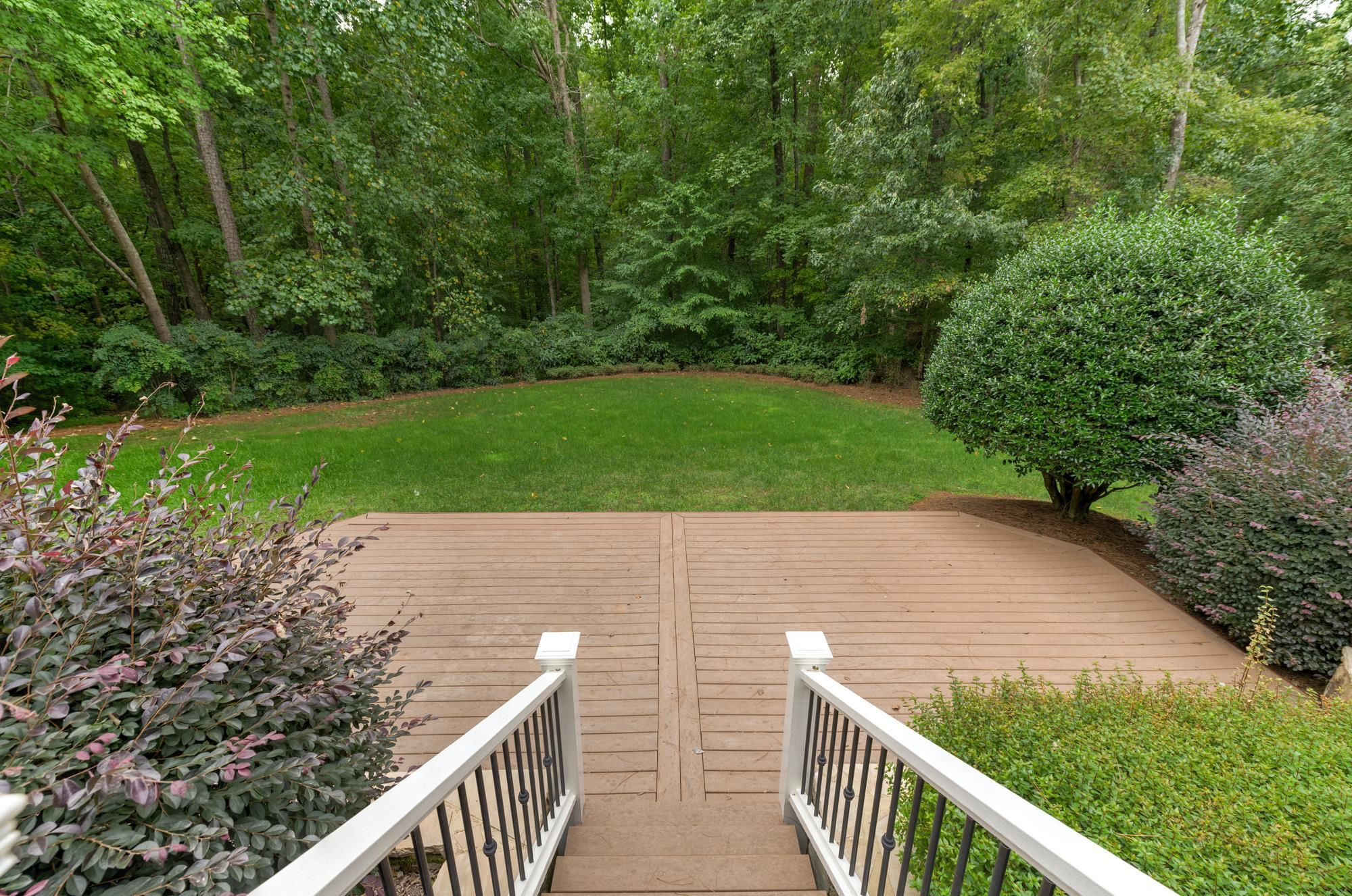 1417 Caistor Lane Raleigh, NC 27614 - Photo 36 of 42 Lower tier patio overlooking the gorgeous mature lawn that backs to greenbelt so it will remain private!