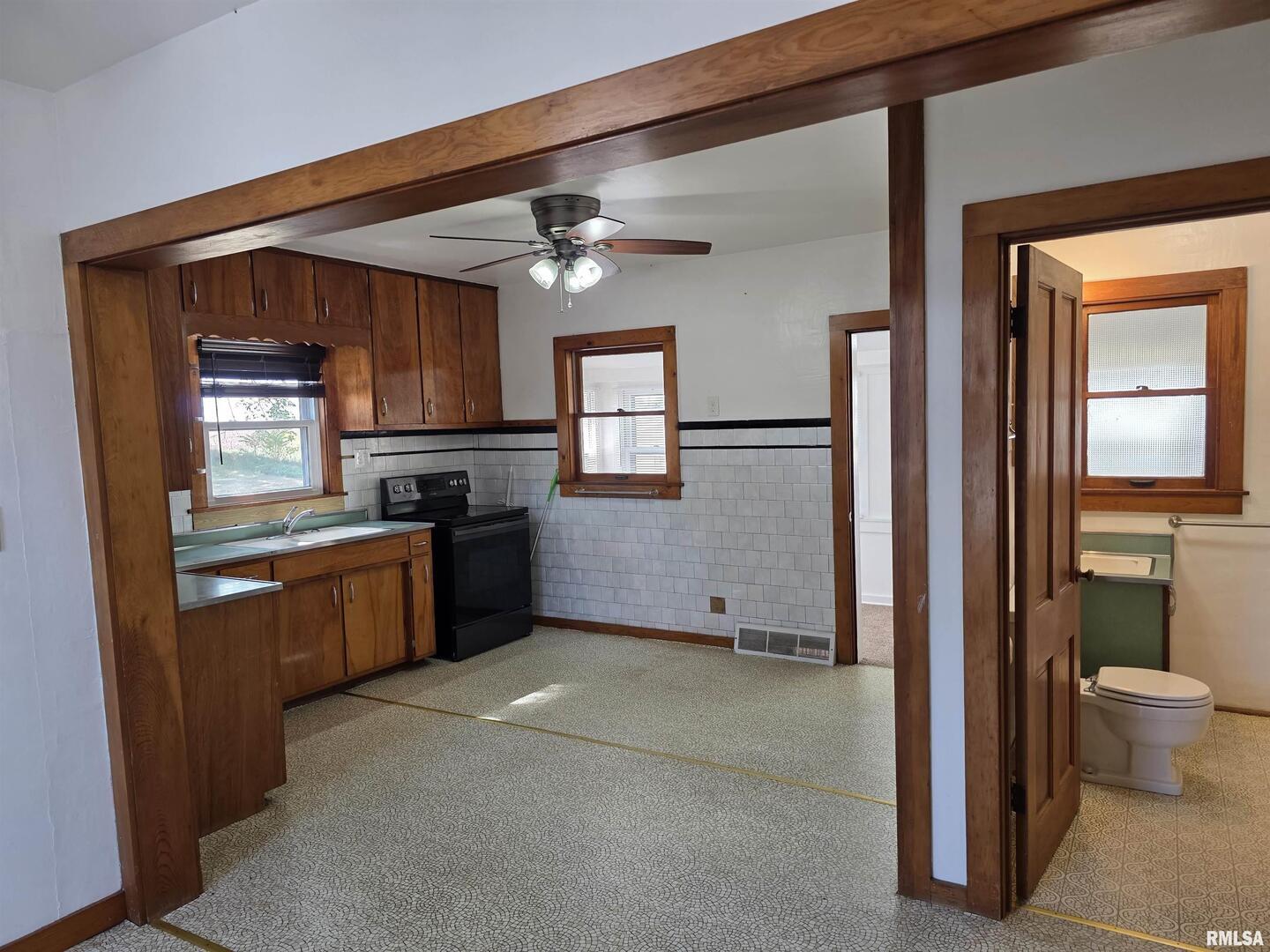 13600 Kennedy Road Fulton, IL 61252 - Photo 12 of 42 a kitchen with stainless steel appliances kitchen island granite countertop a refrigerator and a sink