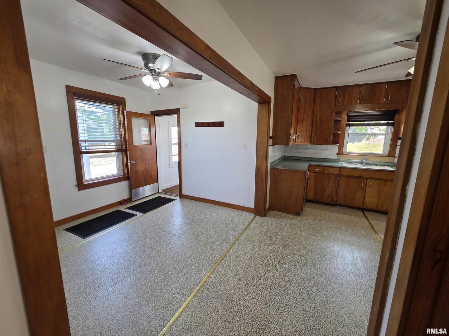 13600 Kennedy Road Fulton, IL 61252 - Photo 13 of 42 an empty room with windows and cabinet