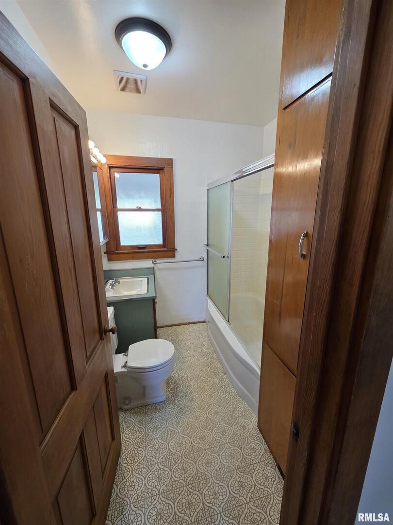 13600 Kennedy Road Fulton, IL 61252 - Photo 14 of 42 a bathroom with a sink a toilet a shower and mirror