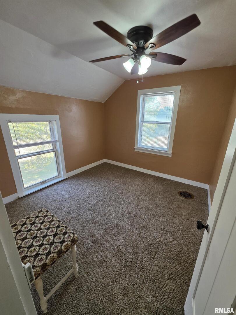 13600 Kennedy Road Fulton, IL 61252 - Photo 21 of 42 an empty room with windows and fan