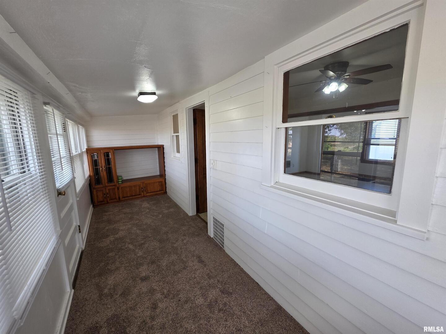 13600 Kennedy Road Fulton, IL 61252 - Photo 5 of 42 a view of hallway with stairs and wooden floor