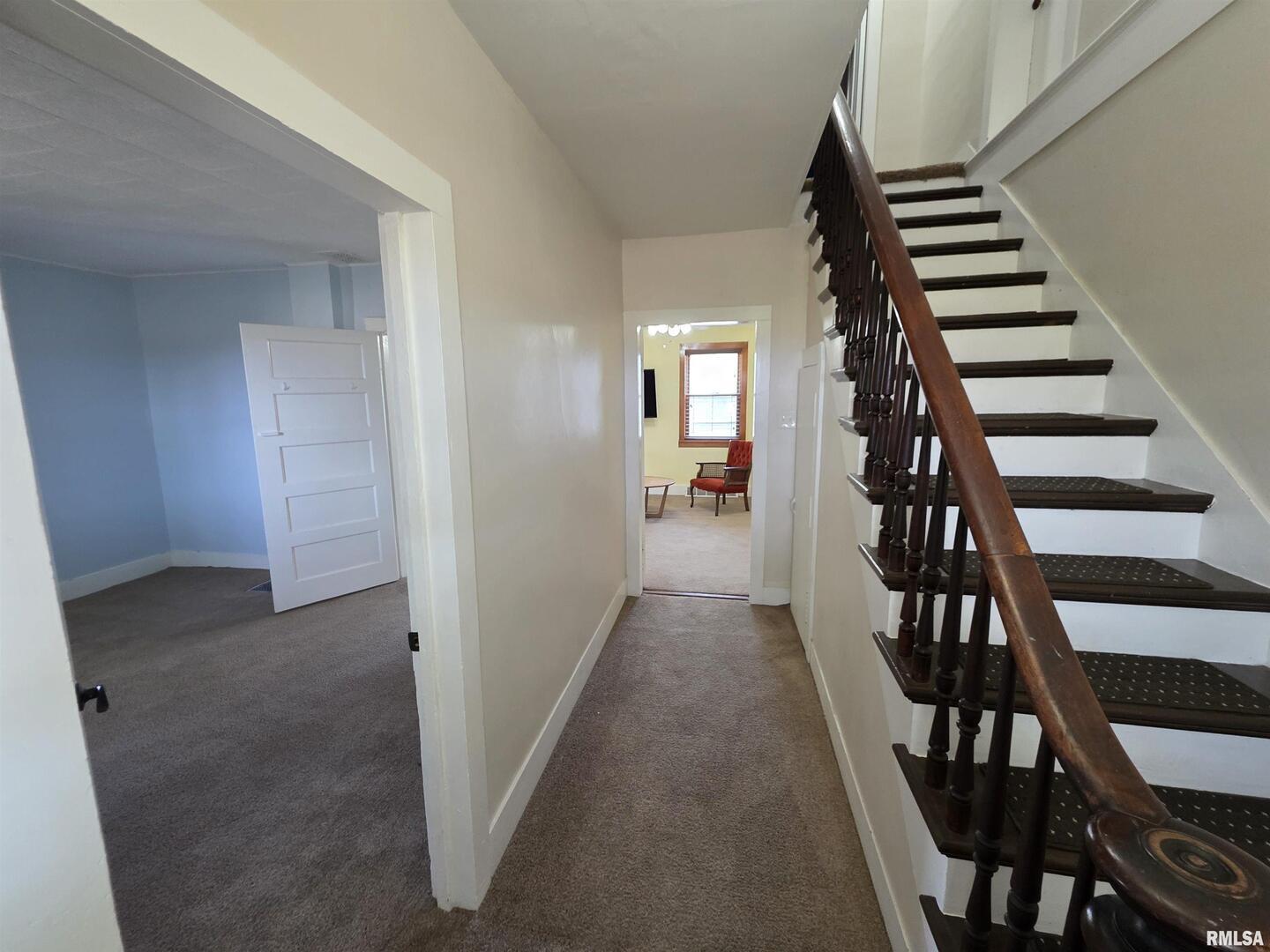 13600 Kennedy Road Fulton, IL 61252 - Photo 6 of 42 a view of a hallway with wooden floor and staircase