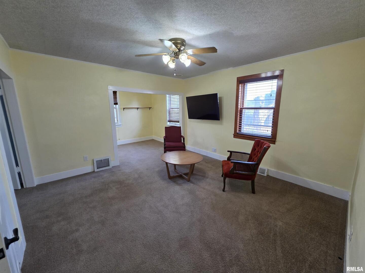 13600 Kennedy Road Fulton, IL 61252 - Photo 7 of 42 a living room with furniture and a chandelier