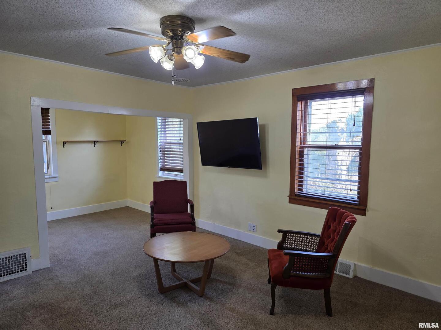 13600 Kennedy Road Fulton, IL 61252 - Photo 8 of 42 a living room with furniture and a flat screen tv