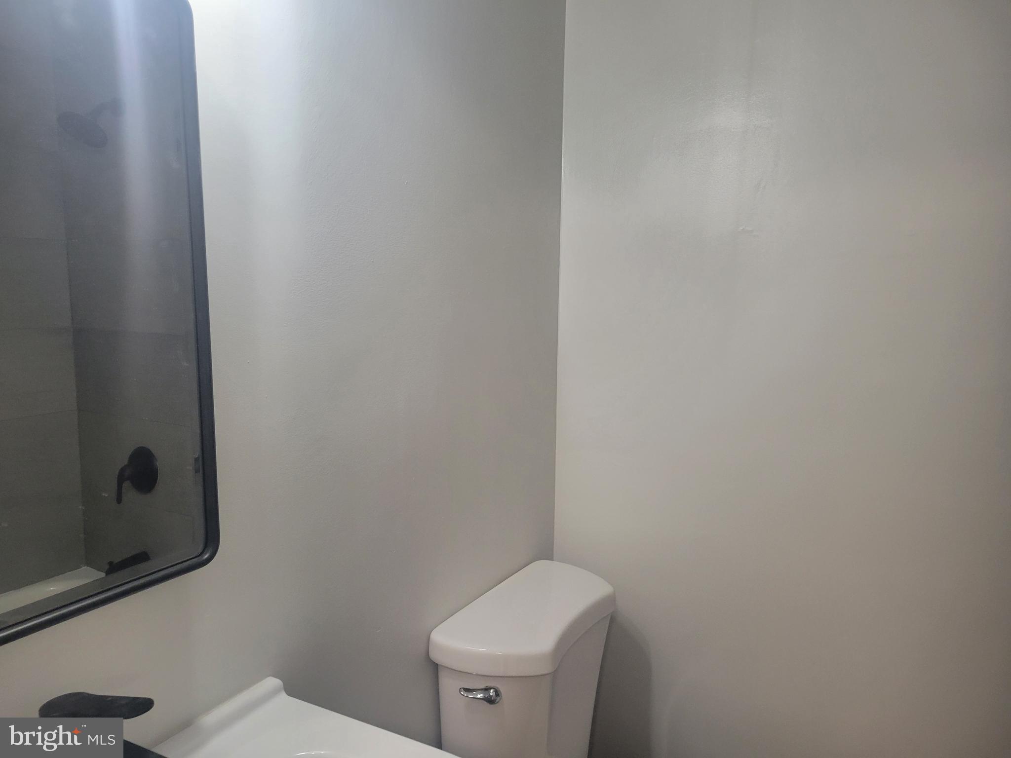 1250 Queen Street Northeast, Unit 1 Washington, DC 20002 - Photo 13 of 13 a white toilet sitting next to a white sink and vanity