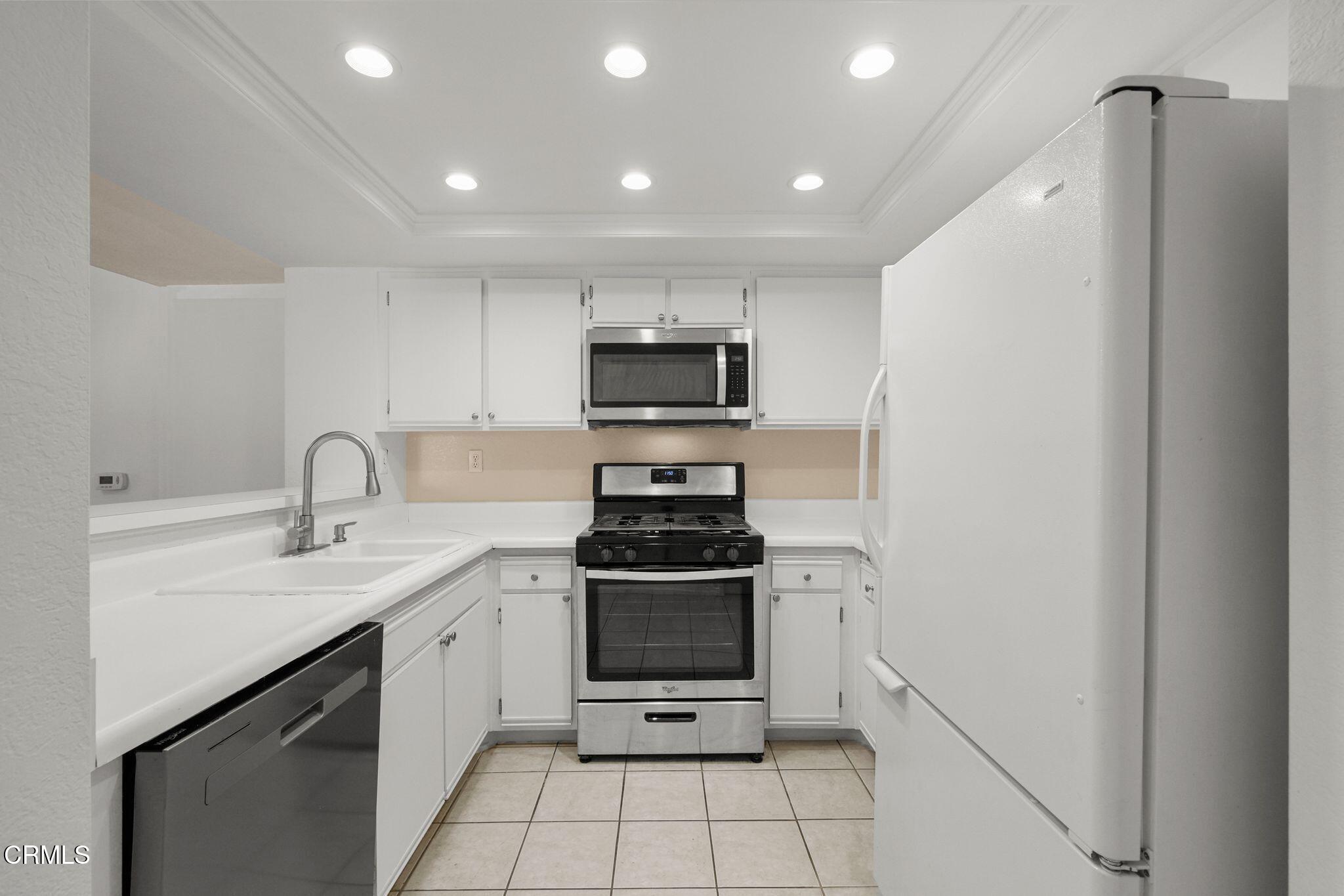 1195 Fitzgerald Road, Unit C Simi Valley, CA 93065 - Photo 14 of 26 a kitchen with a stove and a sink