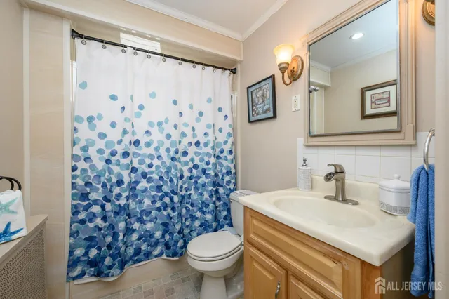 a bathroom with a sink toilet and a mirror