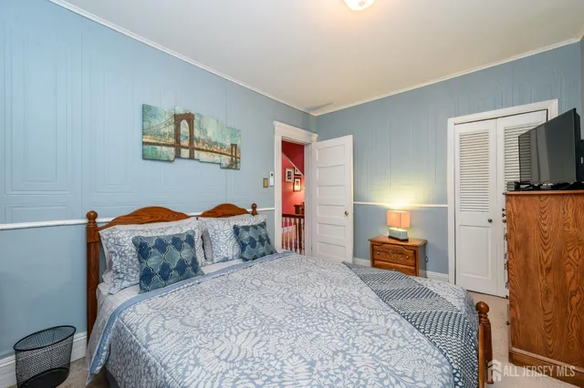 a bedroom with bed and a couch