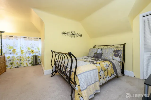 a bed sitting in a bedroom next to a wall