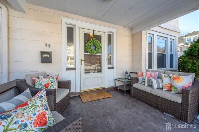 a living room filled with furniture and a potted plant