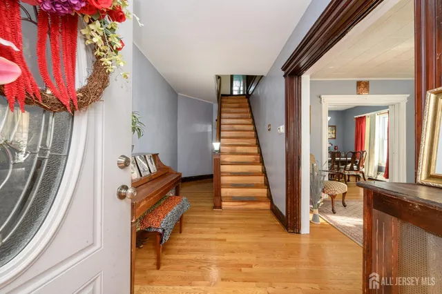 a view of entryway and hall with wooden floor