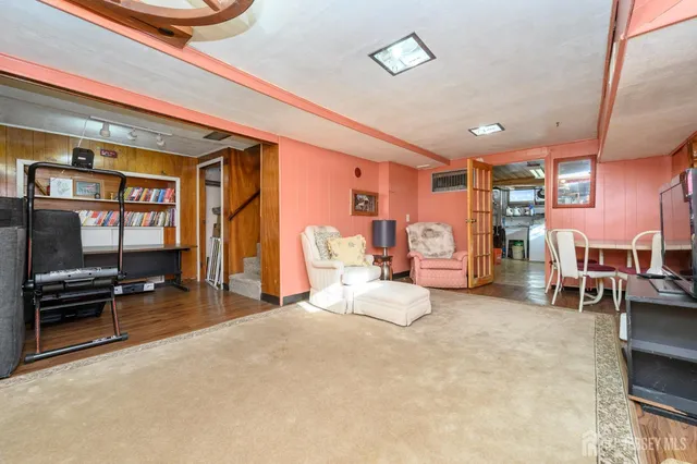 a bedroom with furniture and a flat screen tv