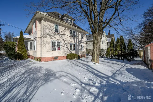 a view of white house with a yard