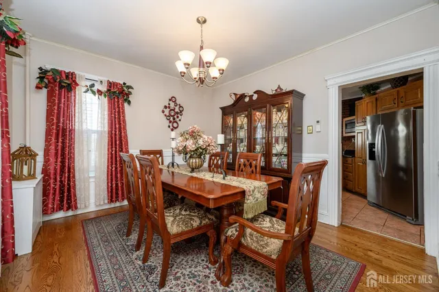 a view of a dining room with furniture and a chandelier