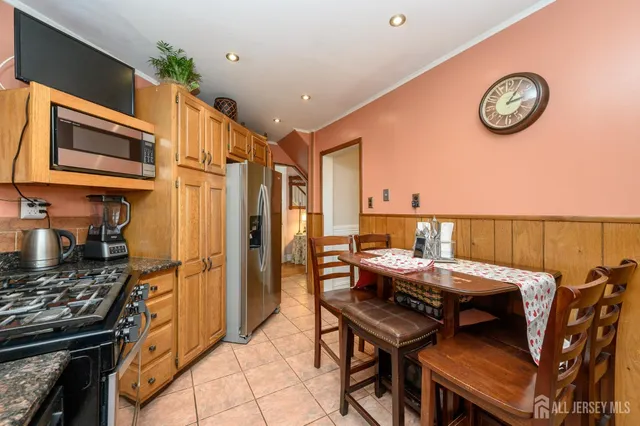 a view of a dining room with furniture and a kitchen
