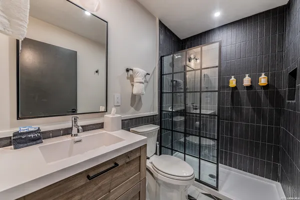 a bathroom with a sink toilet and shower