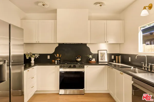 a kitchen with a sink and white cabinets