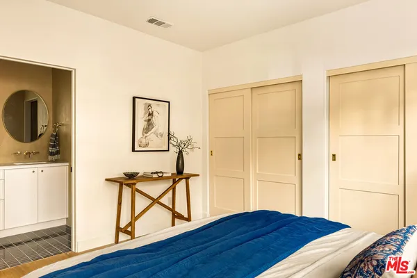 a view of a bedroom with furniture and wooden floor