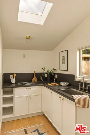 a kitchen with a sink and cabinets