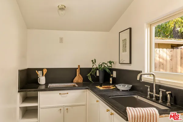 a kitchen with a sink and a stove top oven