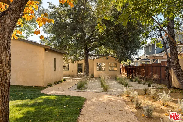 a view of a backyard with large trees
