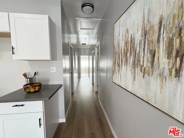 a view of hallway with wooden floor
