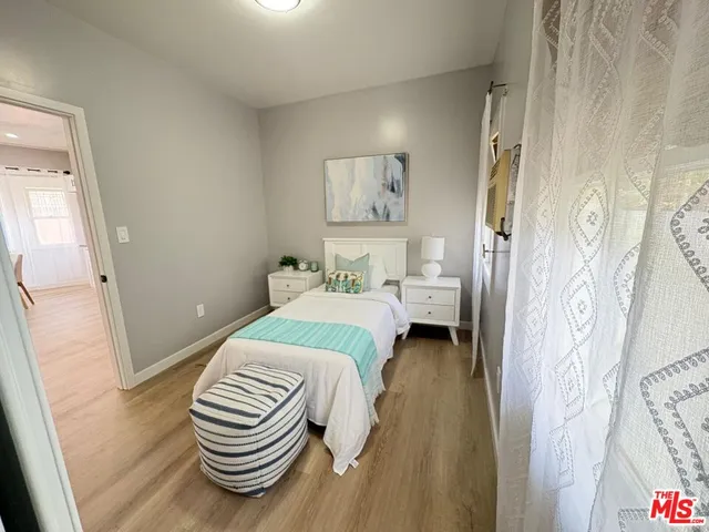 a bedroom with a bed and a chair