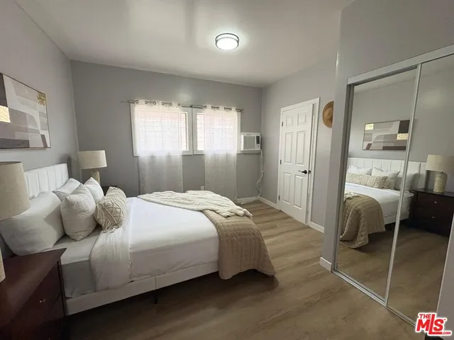 a bedroom with a bed and a dresser