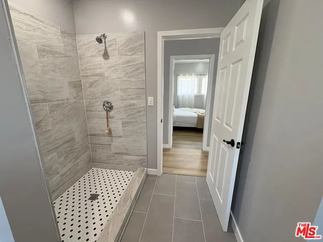 a bathroom with a glass door shower