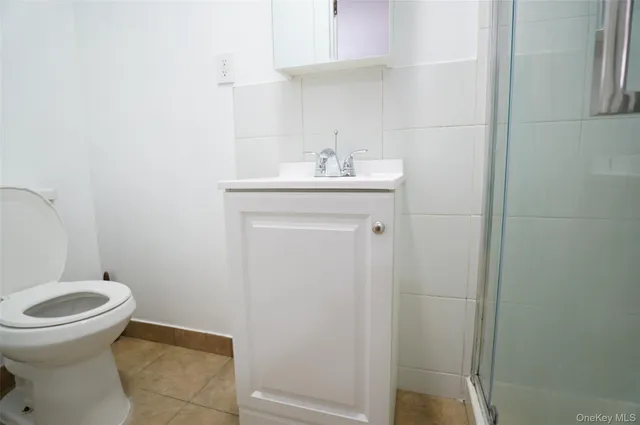 a view of an empty room with window and fire place