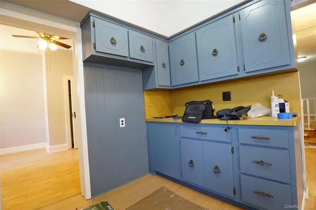 a kitchen with white cabinets and a stove