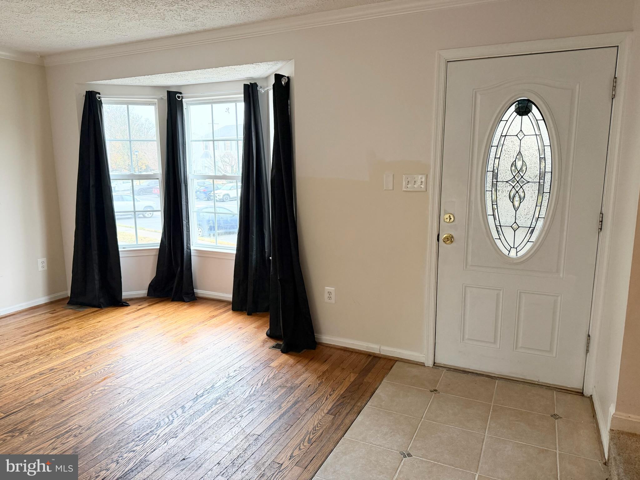 2047 Riding Crop Way Windsor Mill, MD 21244 - Photo 3 of 45 an empty room with window a swimming pool and outdoor space