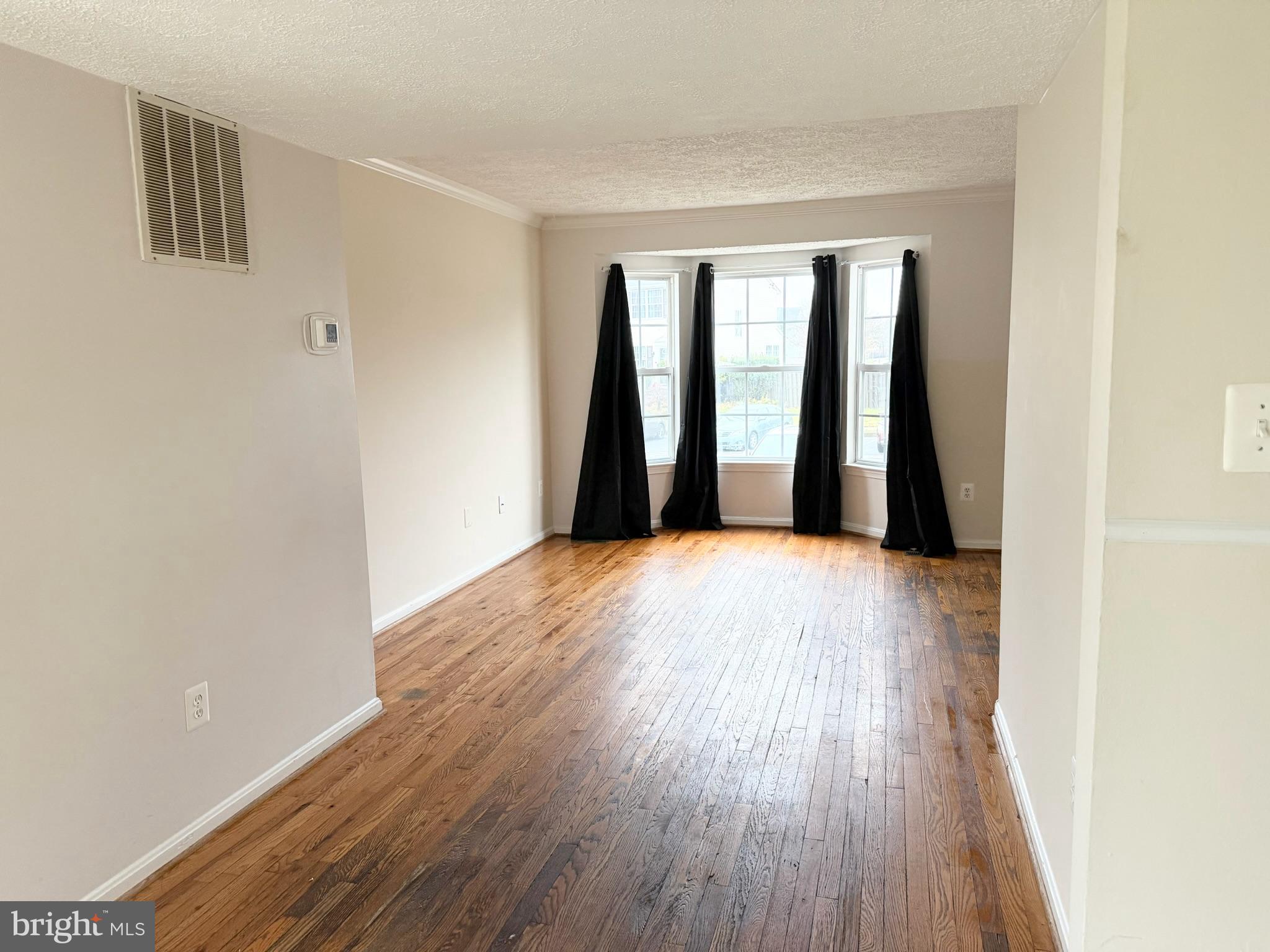 2047 Riding Crop Way Windsor Mill, MD 21244 - Photo 8 of 45 a view of an empty room with wooden floor and a window