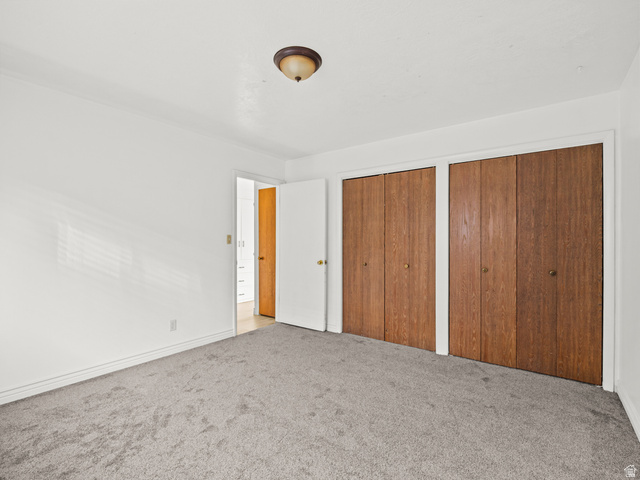 460 200 South Provo, UT 84606 - Photo 28 of 66 Unfurnished bedroom featuring two closets and light carpet