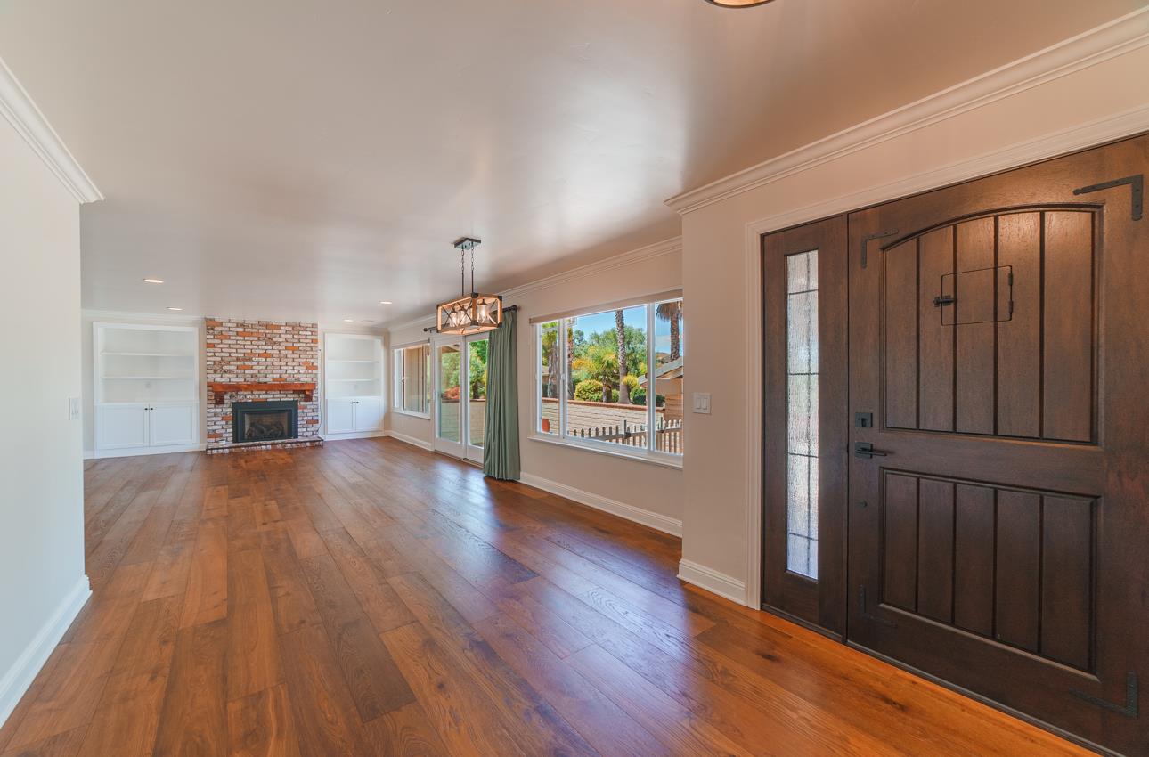 22125 Ranchito Drive Salinas, CA 93908 - Photo 19 of 66 an empty room with wooden floor fireplace and windows