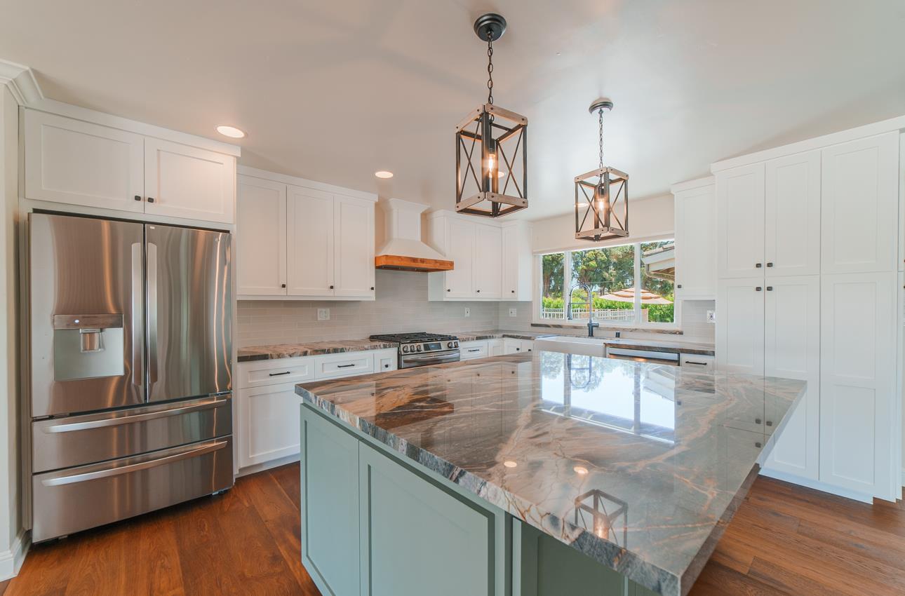 22125 Ranchito Drive Salinas, CA 93908 - Photo 23 of 66 a kitchen with granite countertop a refrigerator a stove a sink a counter space and wooden floor