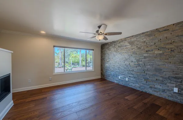 a view of an empty room with wooden floor and cabinet