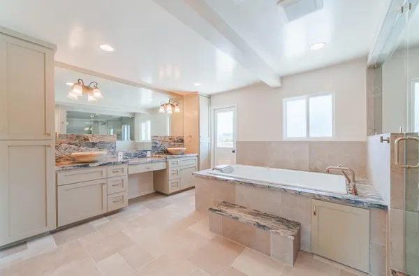 a bathroom with a sink a toilet a mirror and shower