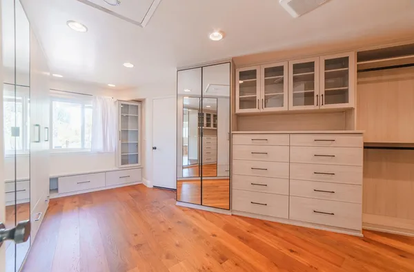 a bathroom with a window a sink and cabinets