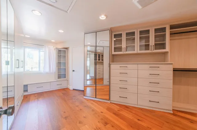 a view of an empty room with a floor to ceiling window and yard
