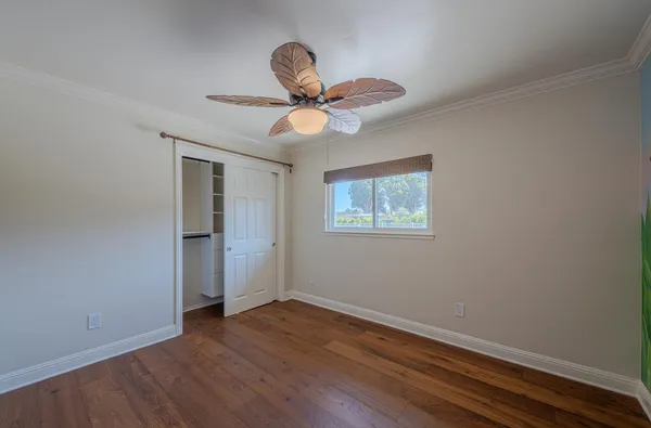 a view of an empty room with a floor to ceiling window and yard