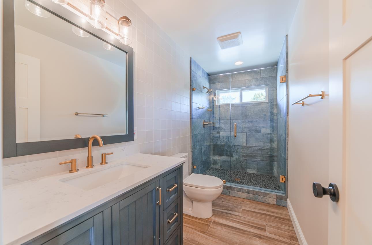 22125 Ranchito Drive Salinas, CA 93908 - Photo 44 of 66 a bathroom with a sink a toilet a mirror and shower