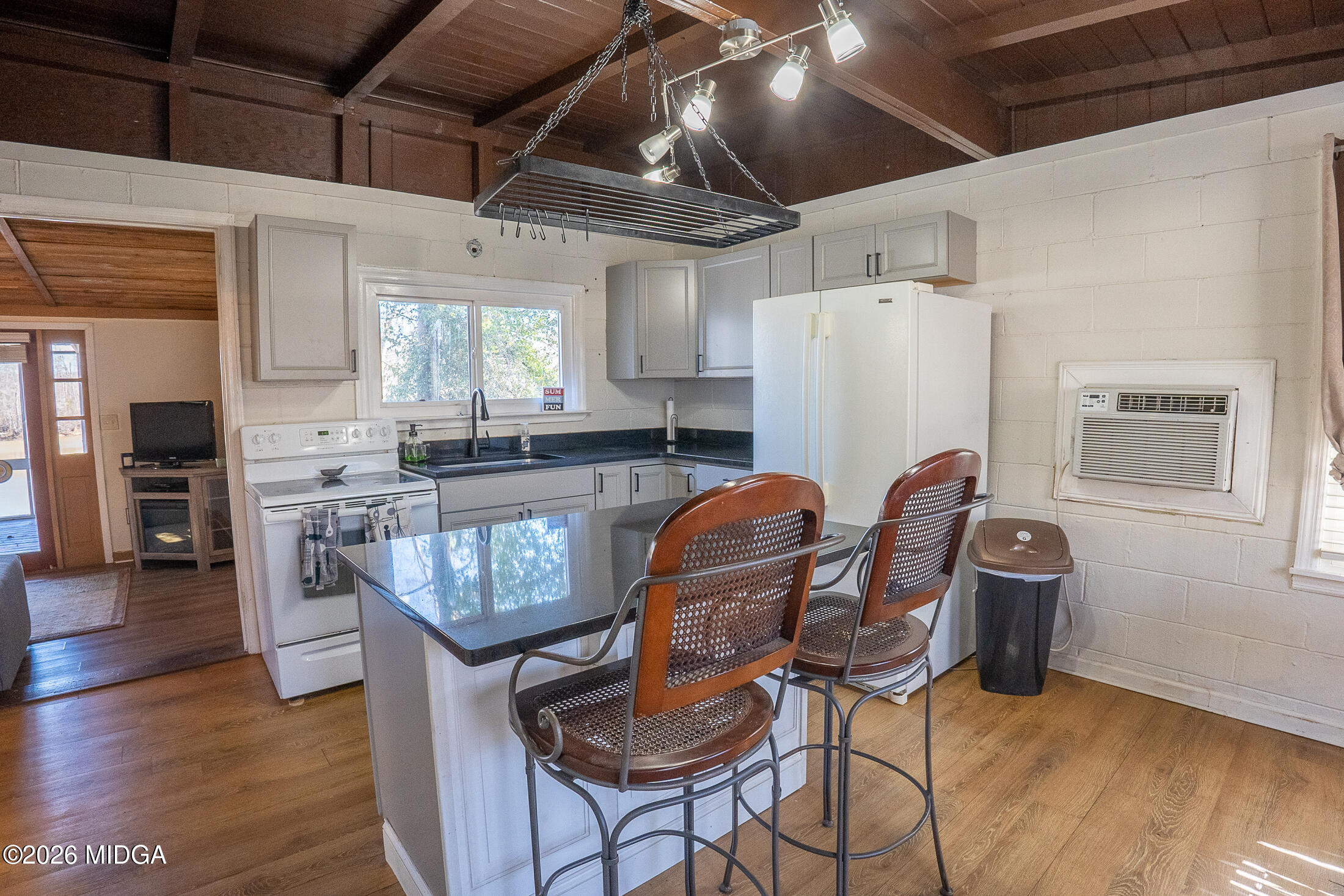 199 Cherokee Drive Jackson, GA 30233 - Photo 7 of 25 a view of a kitchen with kitchen island dining table and wooden floor