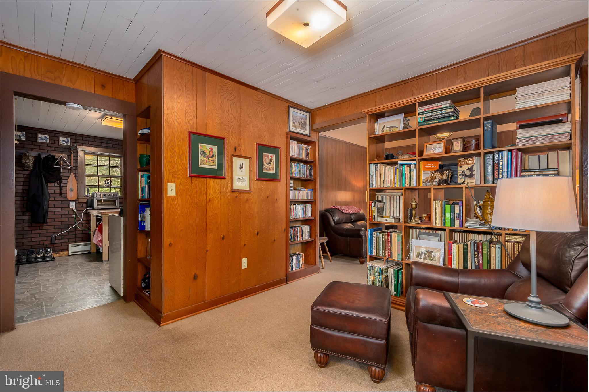 1157 Lakeford Road Terra Alta, WV 26764 - Photo 23 of 37 a living room with furniture cabinets and a book shelf