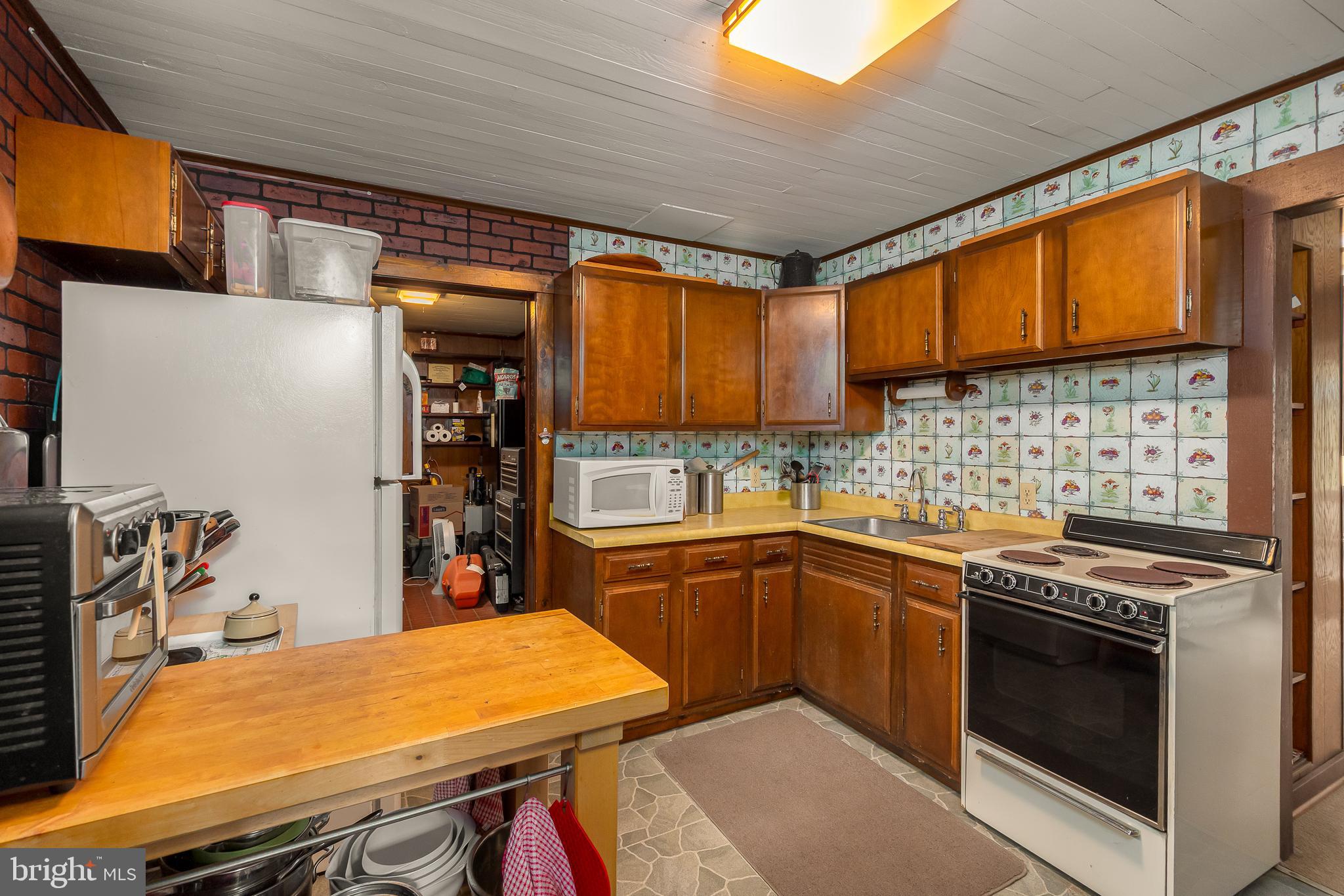 1157 Lakeford Road Terra Alta, WV 26764 - Photo 25 of 37 a kitchen with a stove and a microwave