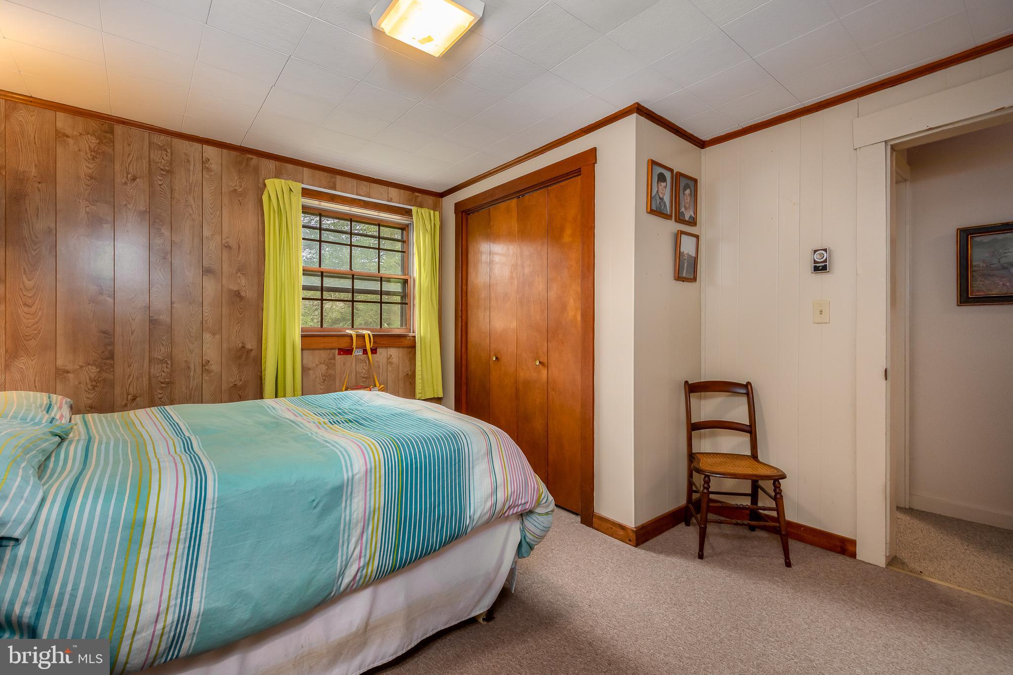 1157 Lakeford Road Terra Alta, WV 26764 - Photo 31 of 37 a bedroom with a bed and a table