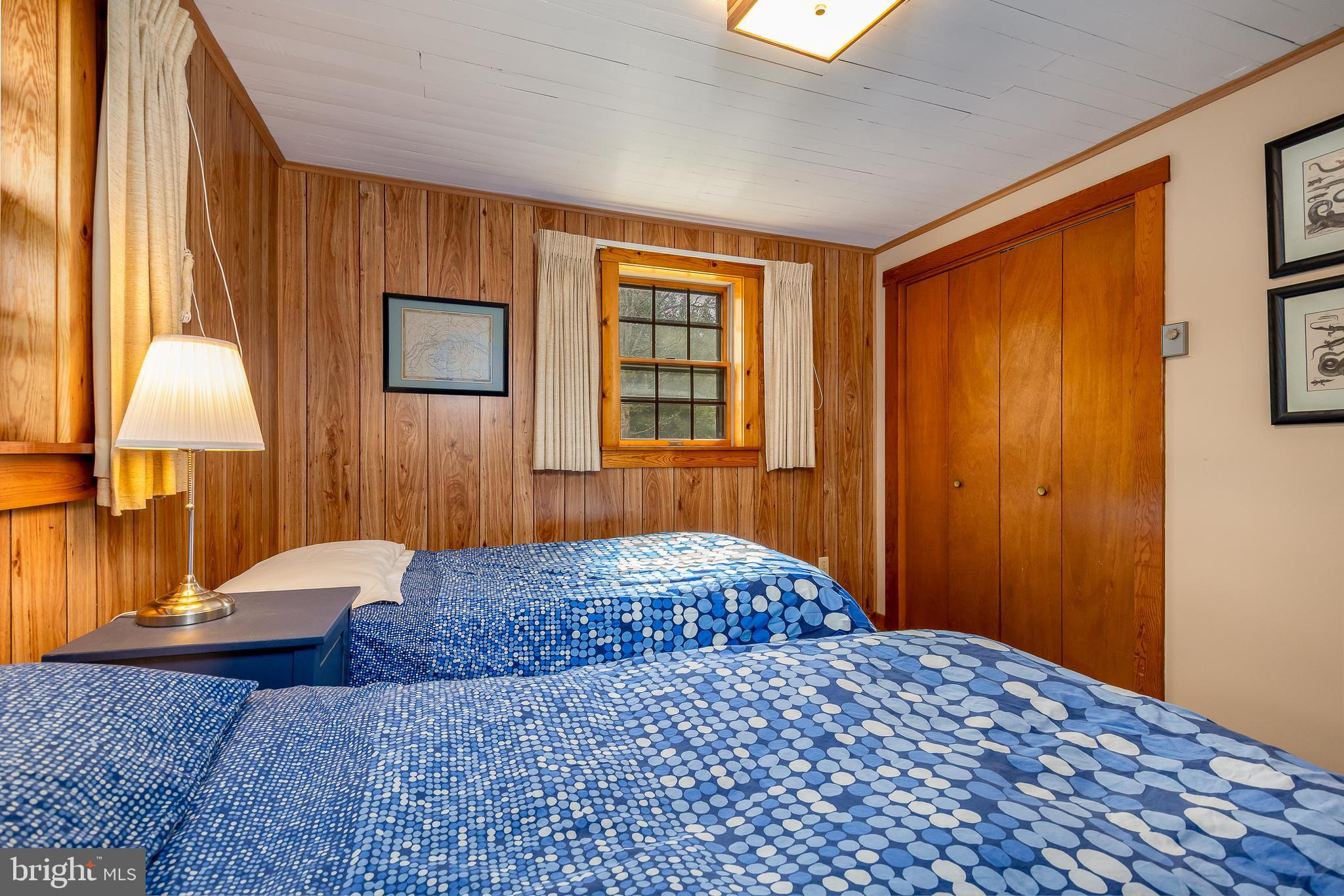 1157 Lakeford Road Terra Alta, WV 26764 - Photo 33 of 37 a bedroom with a bed and a lamp