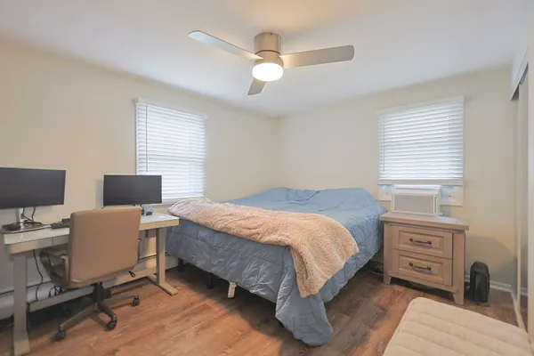 a bedroom with a bed and a desk